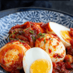 Sambal telur in a blue bowl with text overlay.