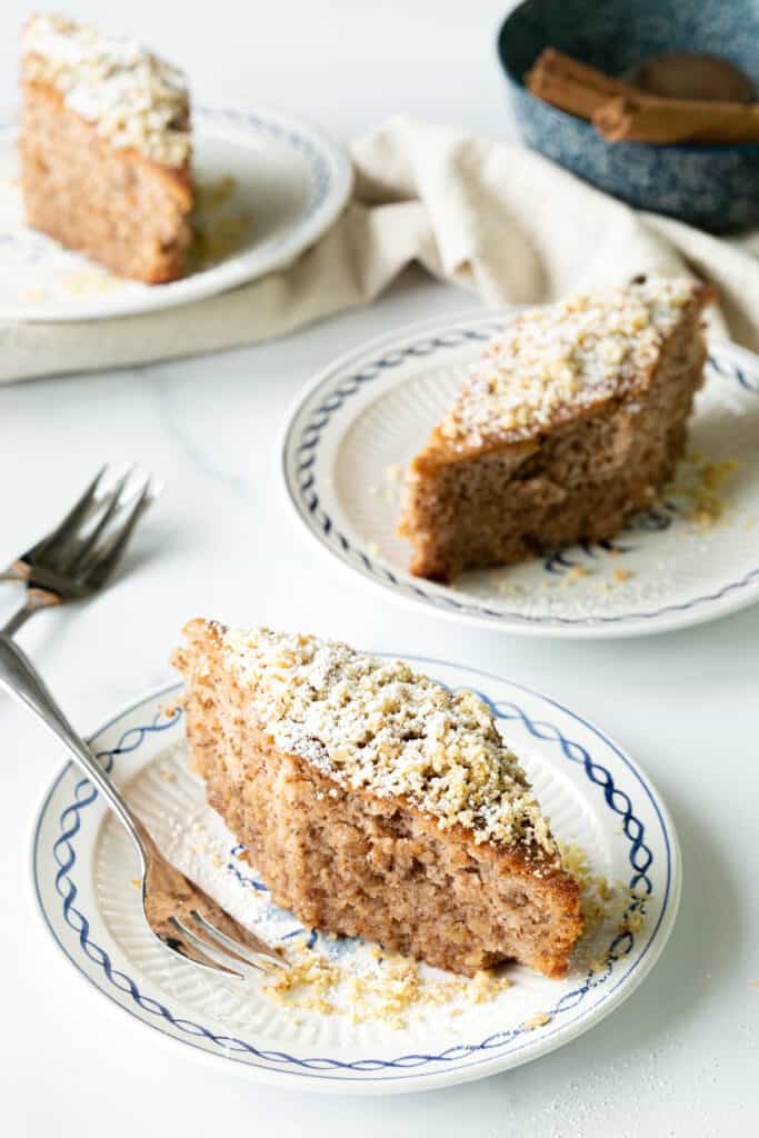 Three plates of Greek walnut cake, with dessert forks ready to eat.