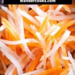 Close up of pickled carrot and daikon strips.