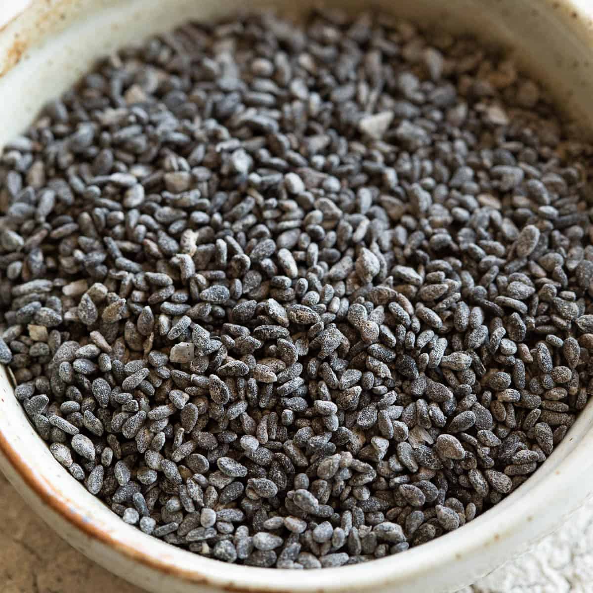 Salt coated black sesame seeds (gomasio) in a dish.