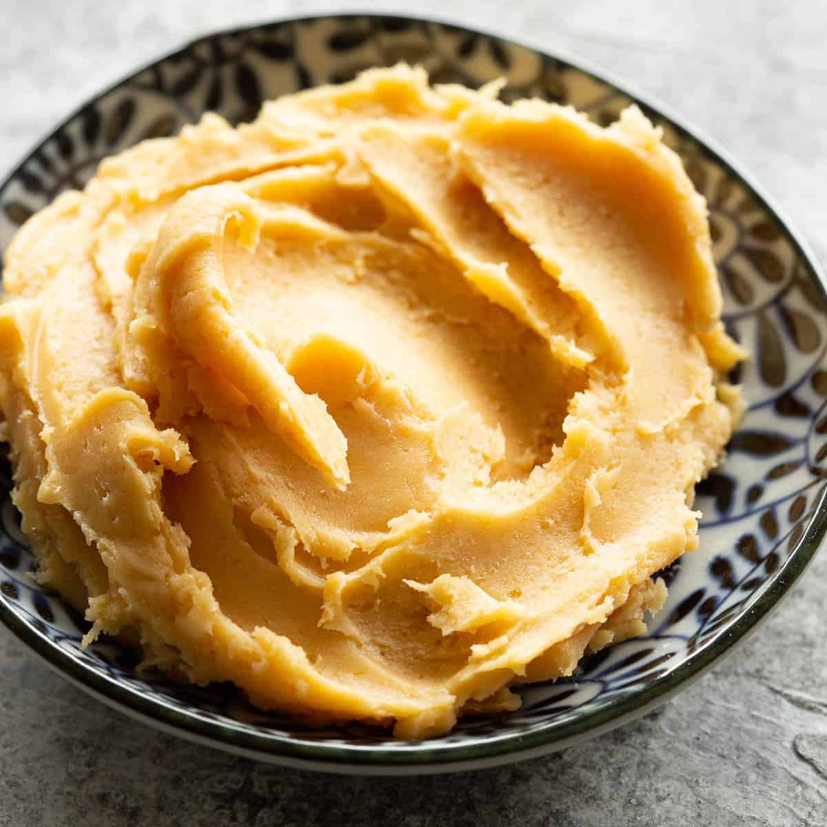Golden and creamy miso butter in a dish, ready to use.
