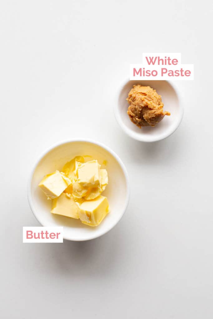 Butter and miso paste laid out on a white board.