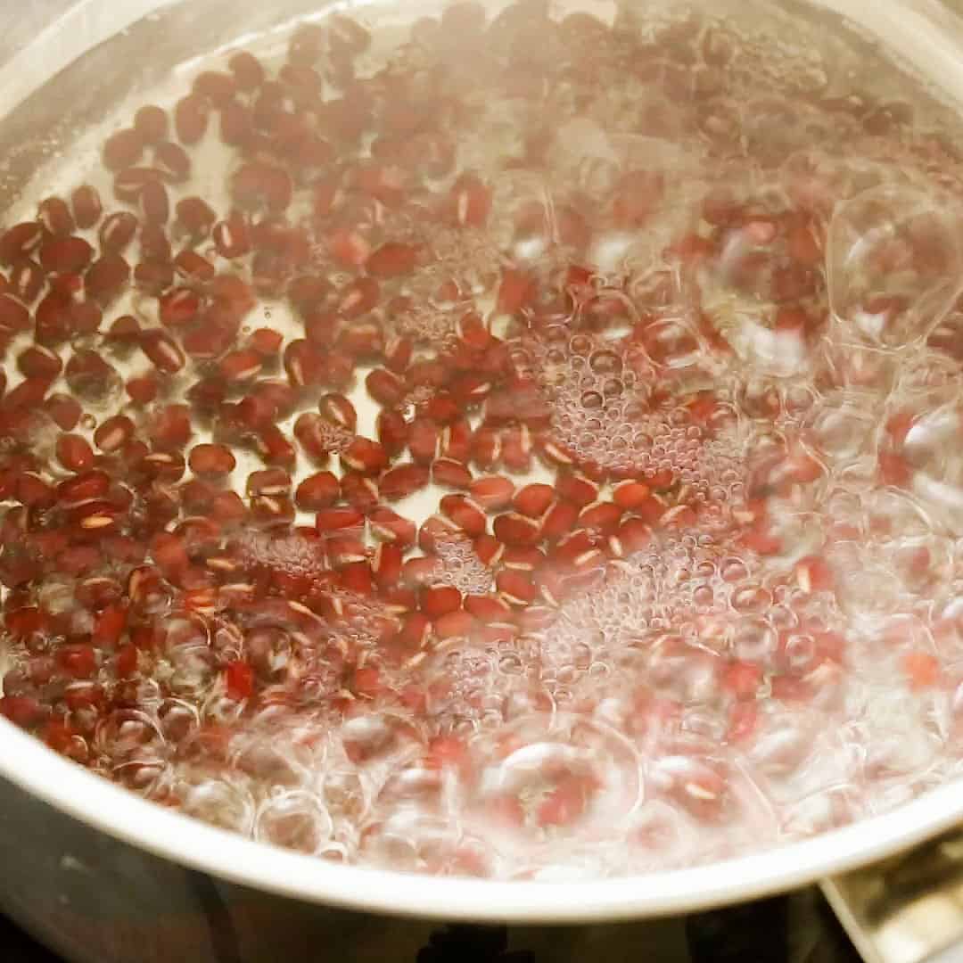 Red beans boiling in a pot.