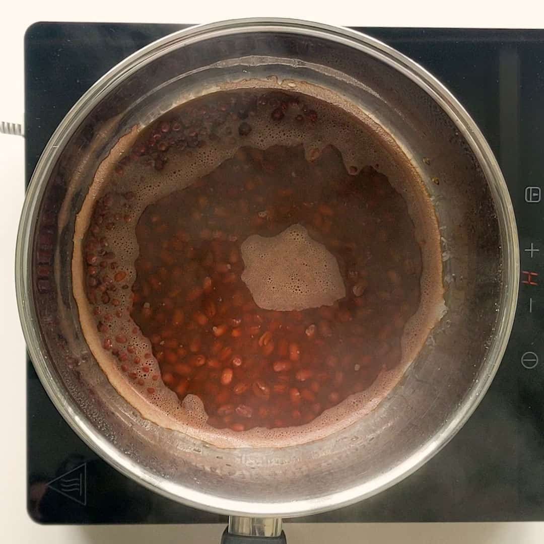 Red beans cooling down in their cooking liquid.