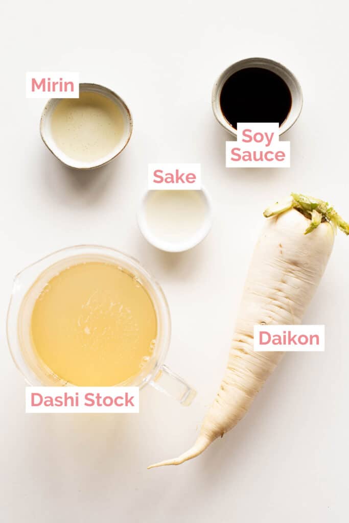 Ingredients laid out for simmered daikon: daikon radish, dashi stock, mirin, sake and soy sauce.