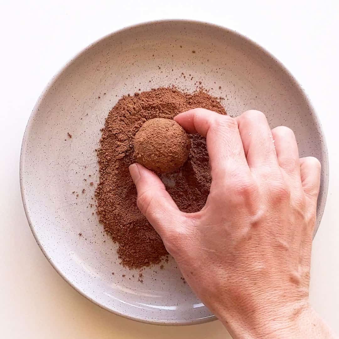 Rolling a coconut ball in milo.