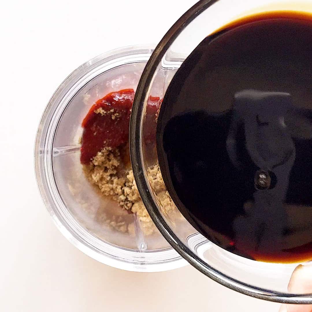 Pouring the soy sauce into the blender.