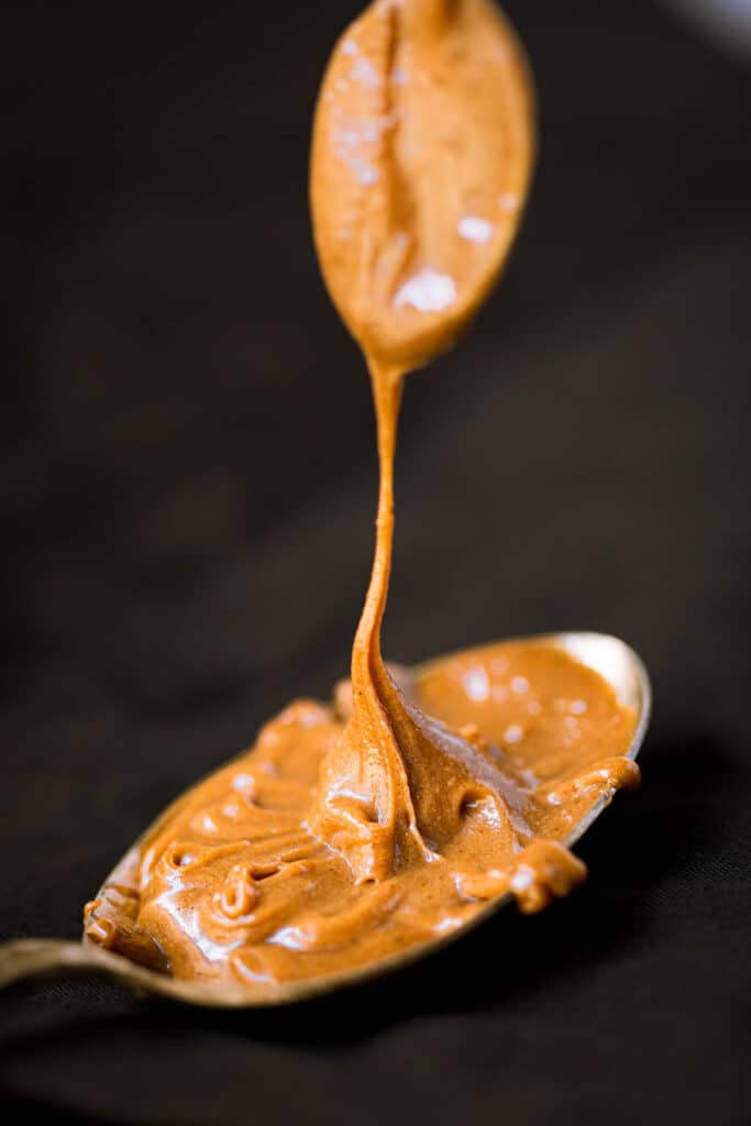 Speculoos cookie butter being drizzled on a spoon.