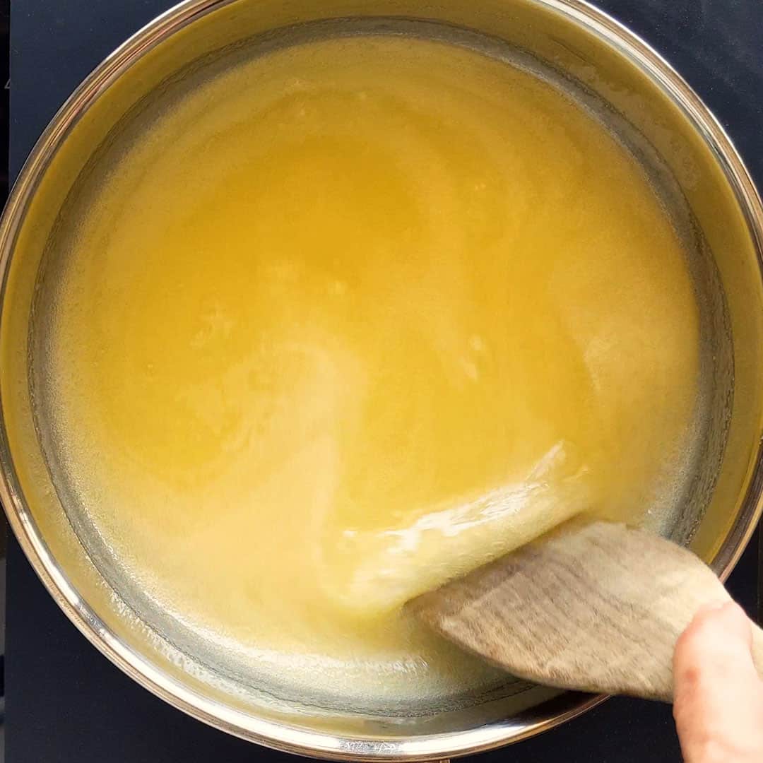 Melting the butter and dissolving the sugar in a large pot.