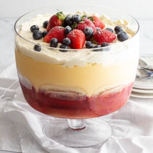 Large trifle with jelly, custard and cream layers.