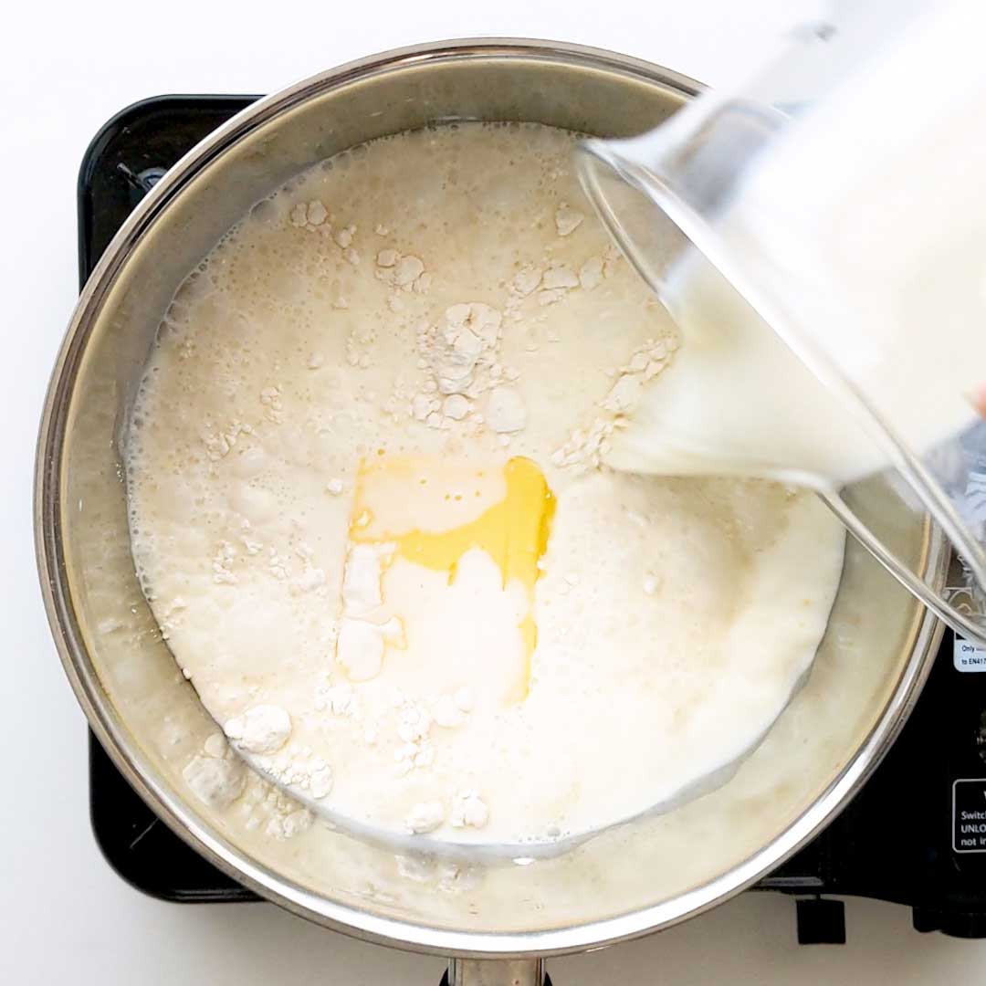 Pouring milk into the saucepan.