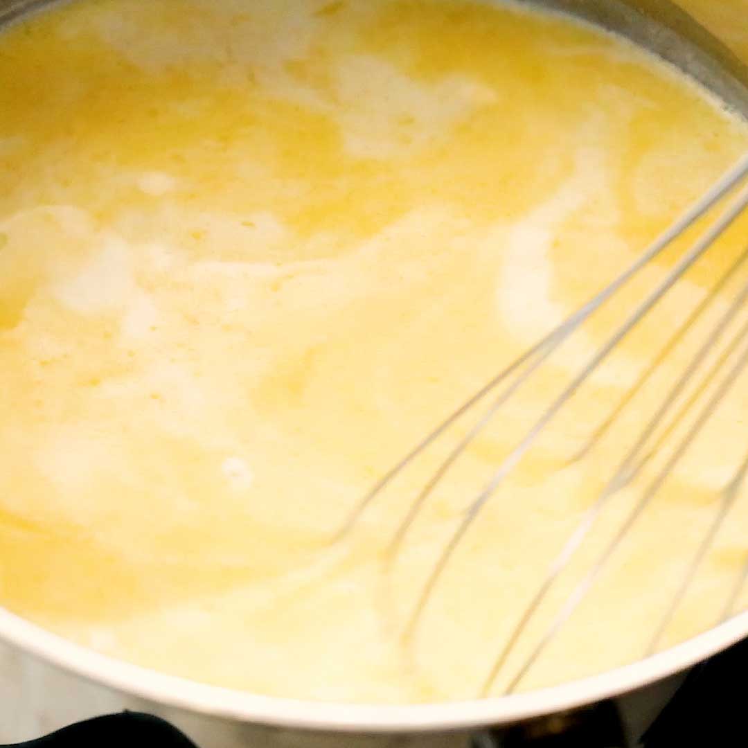 Whisking the white sauce as the butter melts.