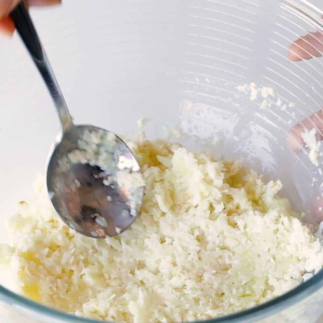 Soaking the panko breadcrumbs in milk and grated onion.