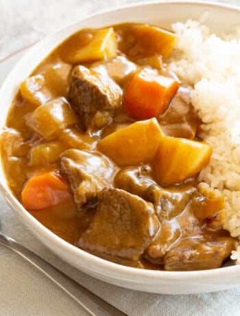 Creamy Japanese beef curry alongside rice in a big bowl.