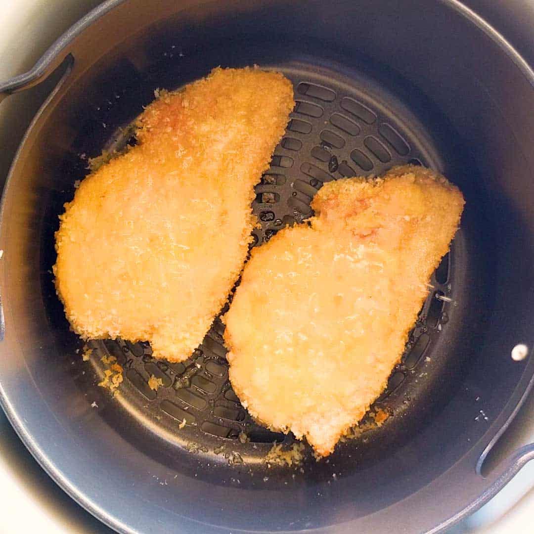 Air frying pork cutlets in panko crumbs.