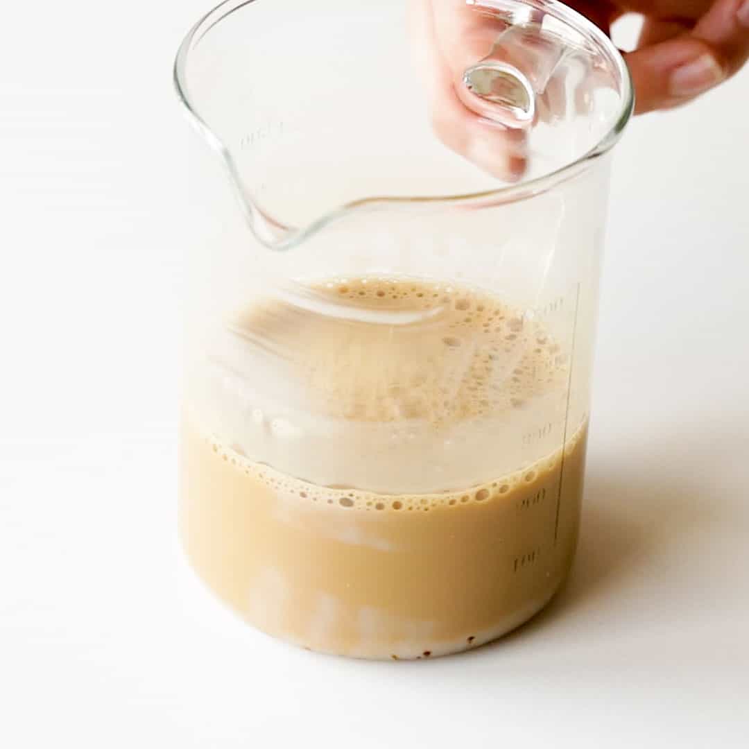 Mixed coffee in a clear glass jug, ready to be pulled.