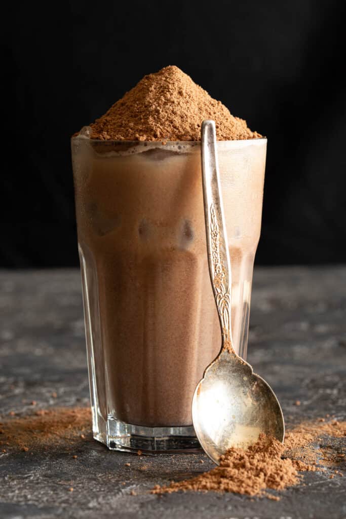 A spoon rests against an icy glass of Milo dinosaur.