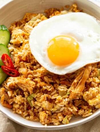 Nasi Goreng dishes up with cucumber, chilli and fried egg.