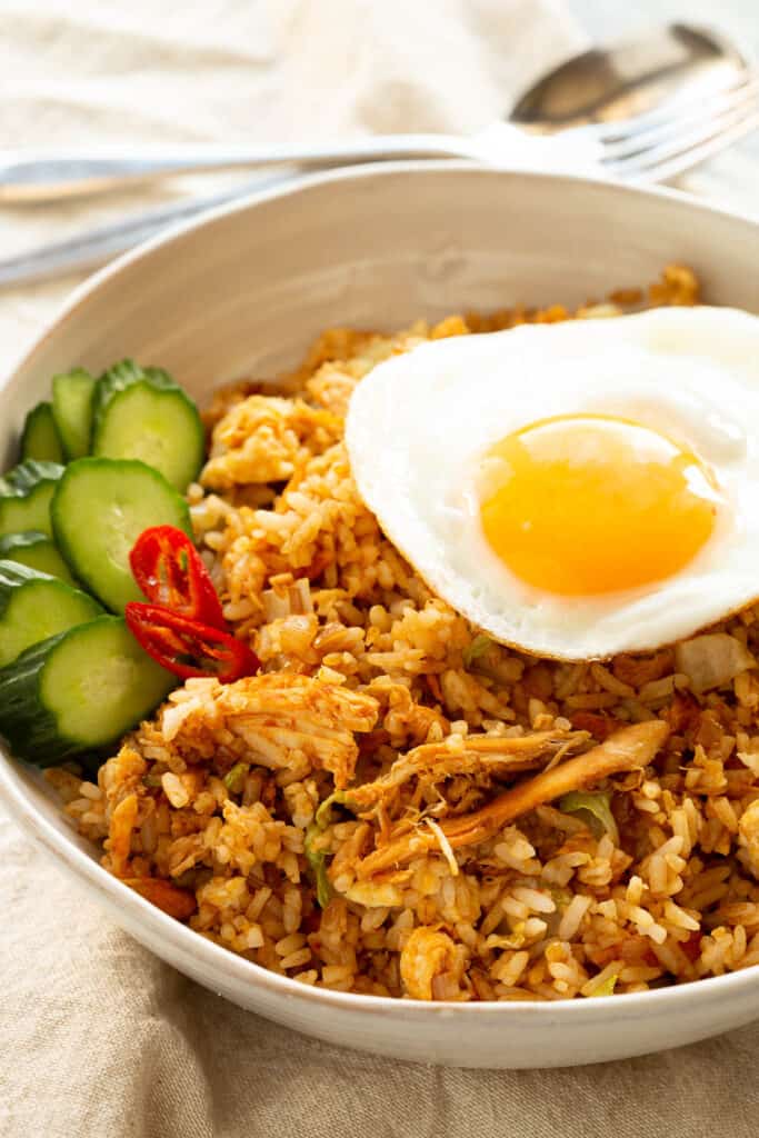A bowl of Nasi Goreng topped with a fried egg.