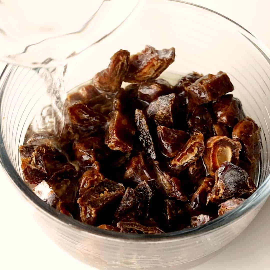 Pouring boiling water over chopped dates.
