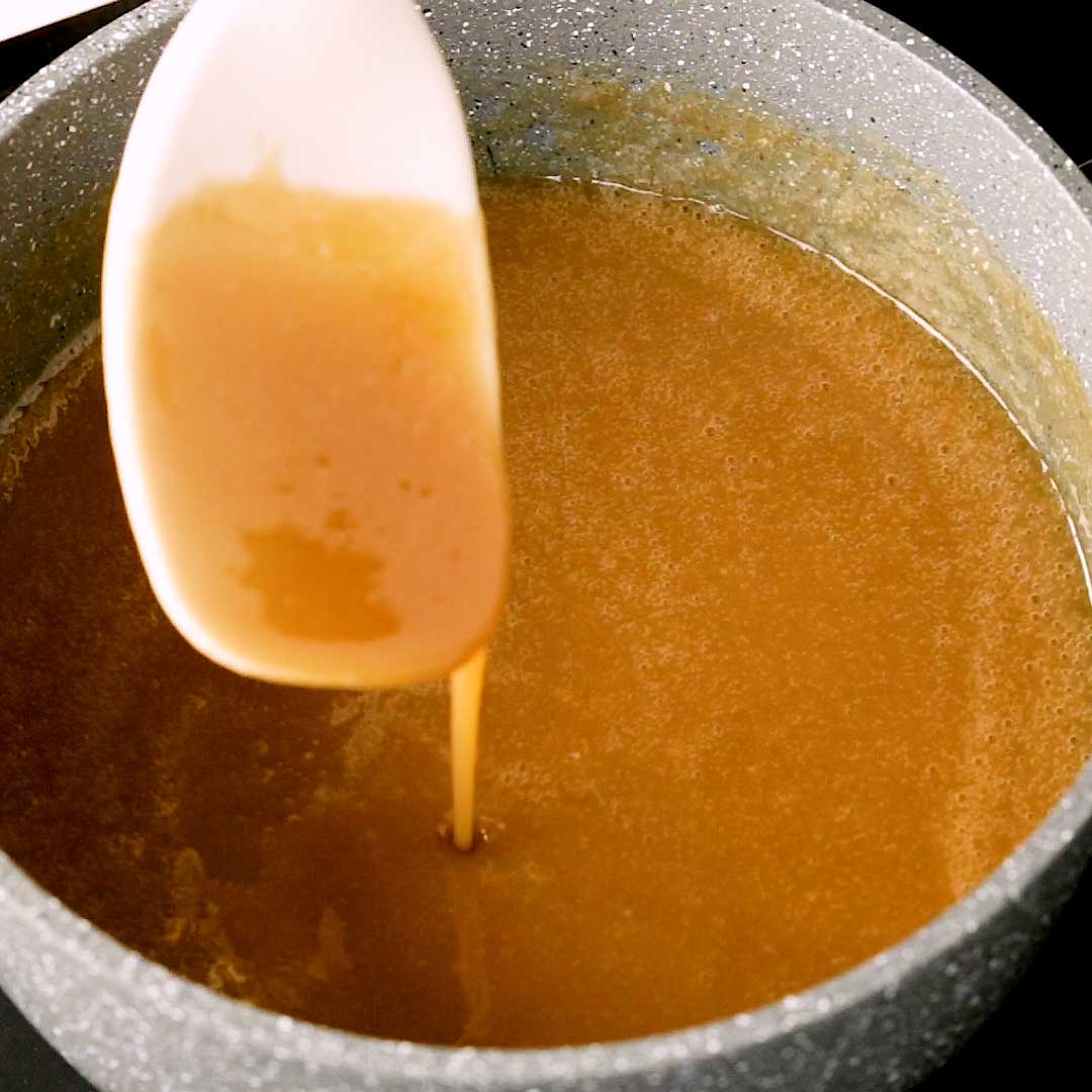 Showing the consistency of the toffee sauce.