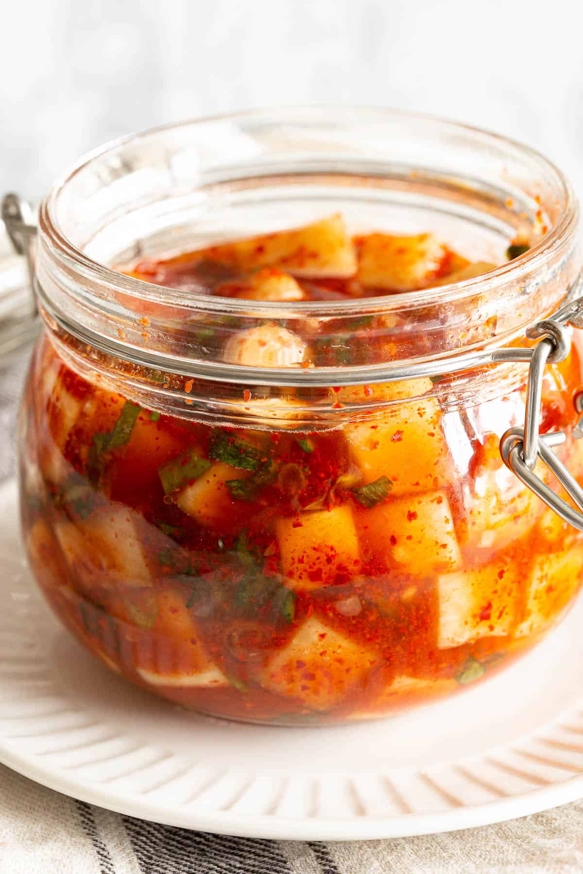 A jar of Korean radish kimchi showing the amount of liquid after being left out overnight.