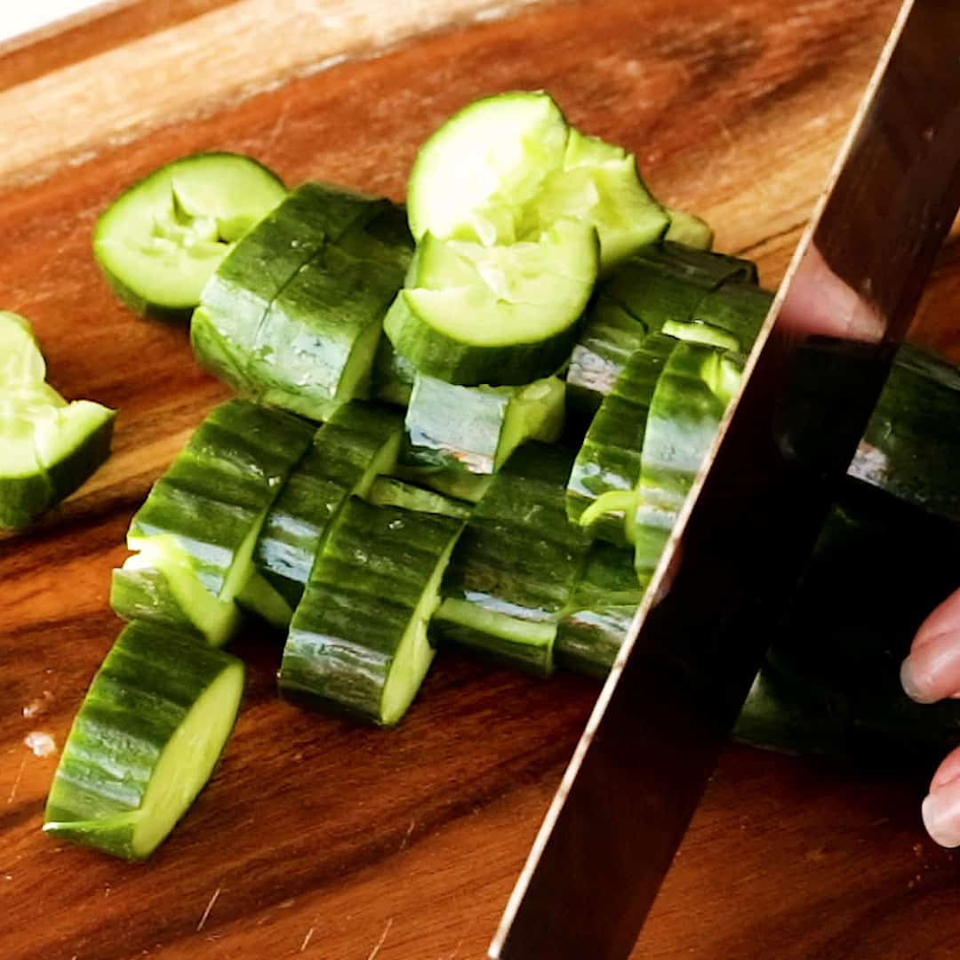 Slicing smashed cucumber.