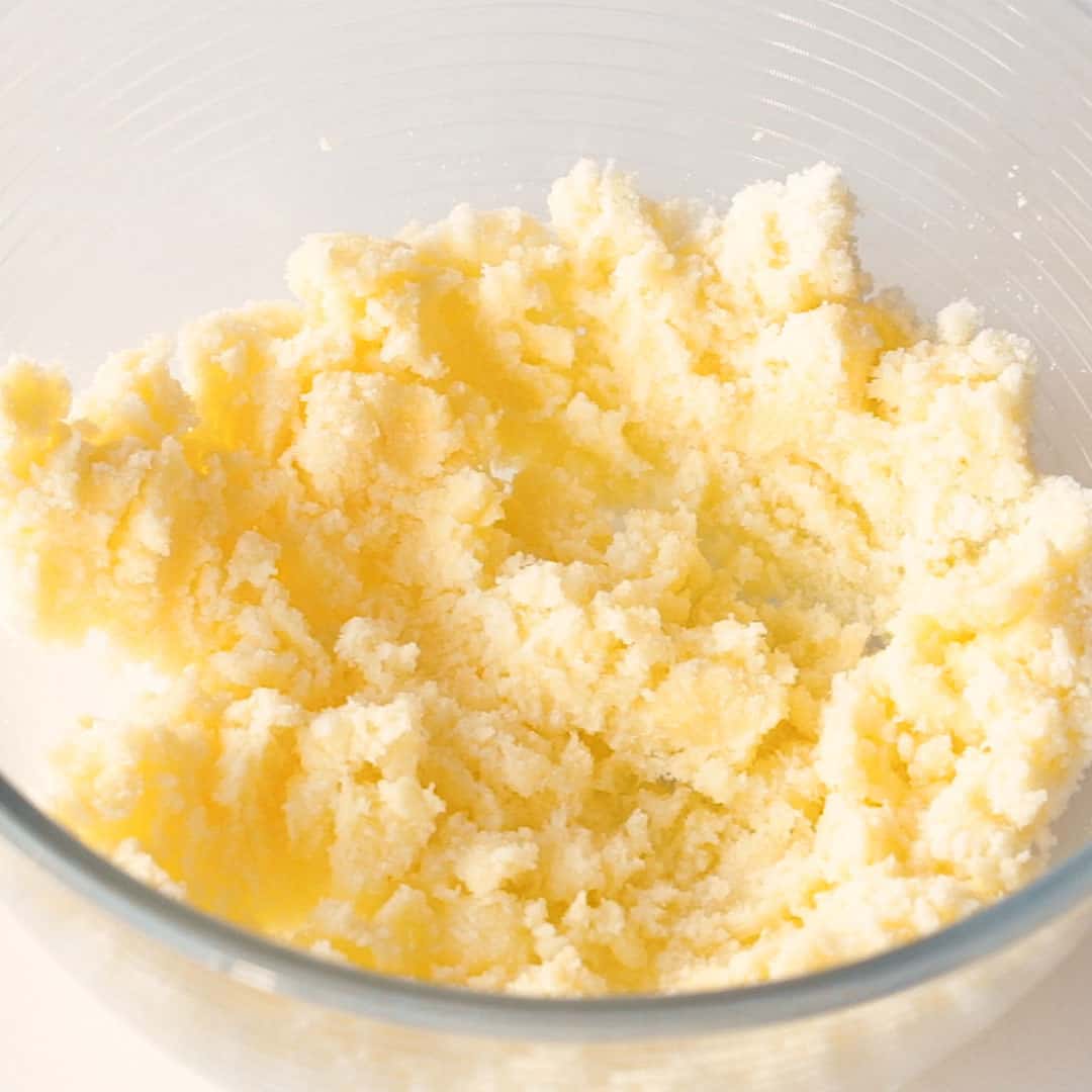 Mixing the butter and sugar together until lightly creamed.
