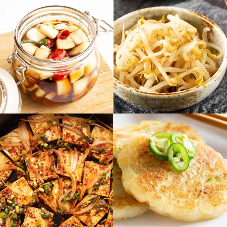 Korean banchan including pickled onion, seasoned bean sprouts, fried tofu and potato pancakes.