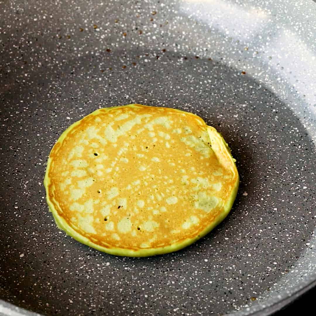 A flipped match pancake showing a beautiful light brown.