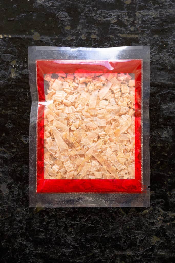 A small clear plastic packet of katsuobushi flakes.
