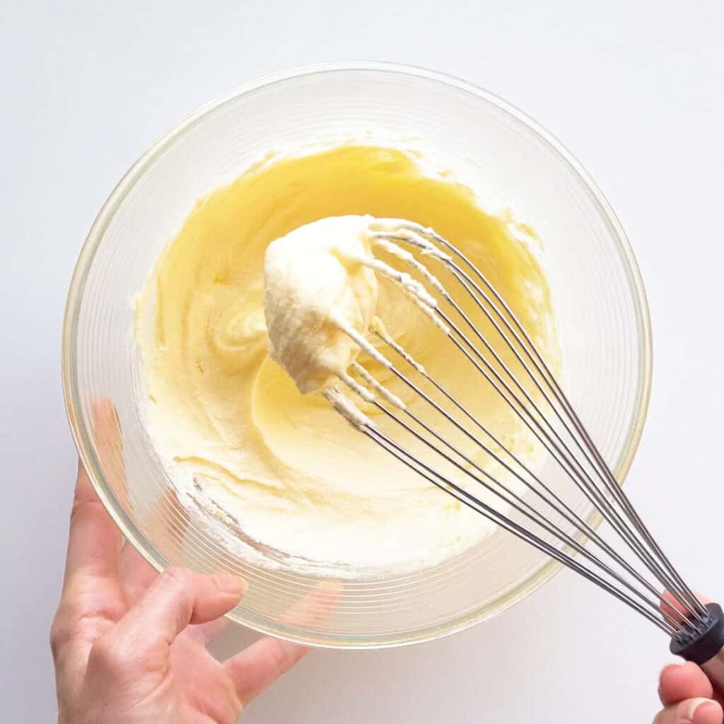 Creaming the butter and sugar with a whisk.