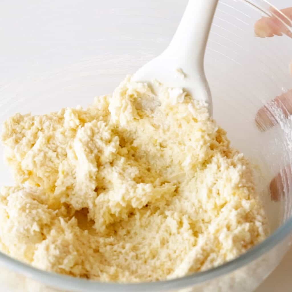 Mixing together the creamed butter and flour.