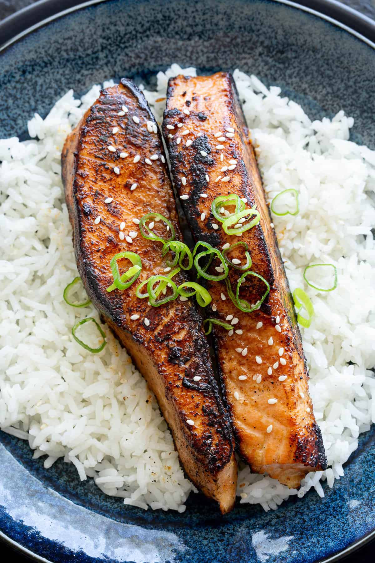 Two salmon steaks that show off the miso glaze and charred edges from cooking.