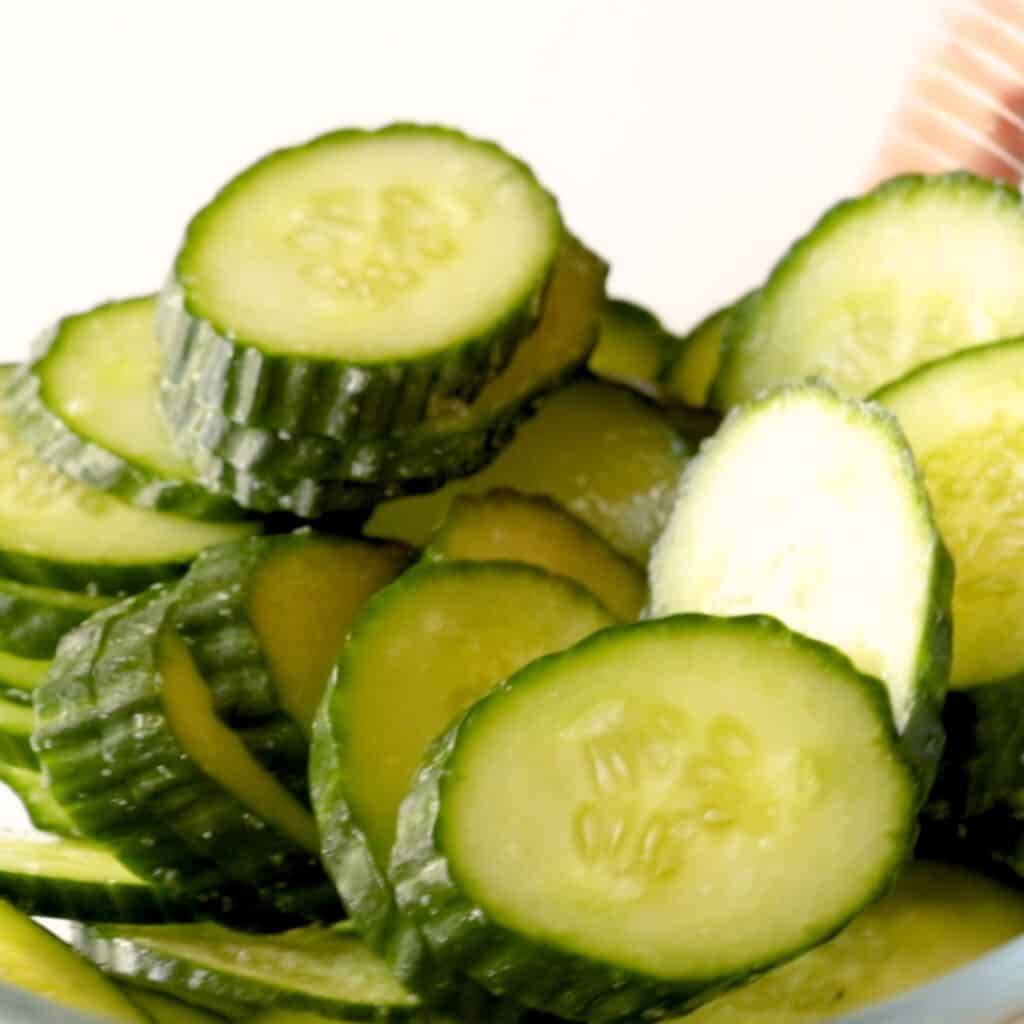 Salting the cucumber in a bowl.