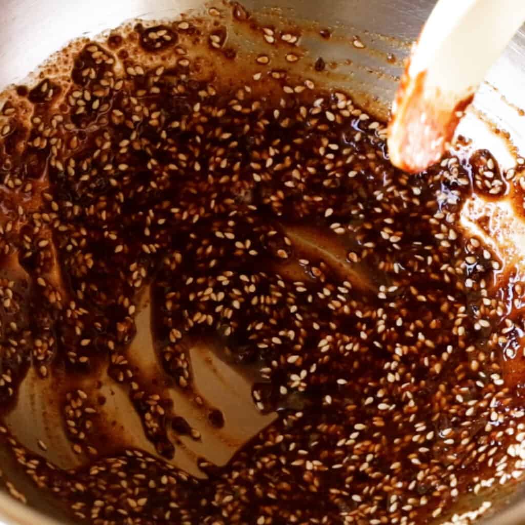 Mixing the spicy salad dressing together.