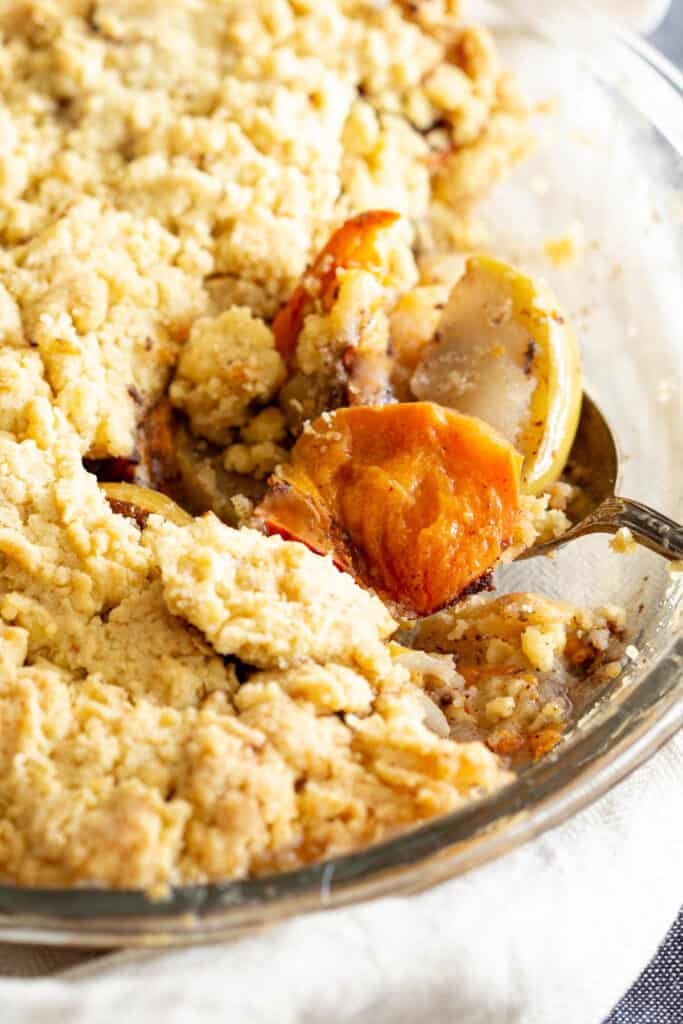 Crispy golden crumble with persimmon and apple pieces.