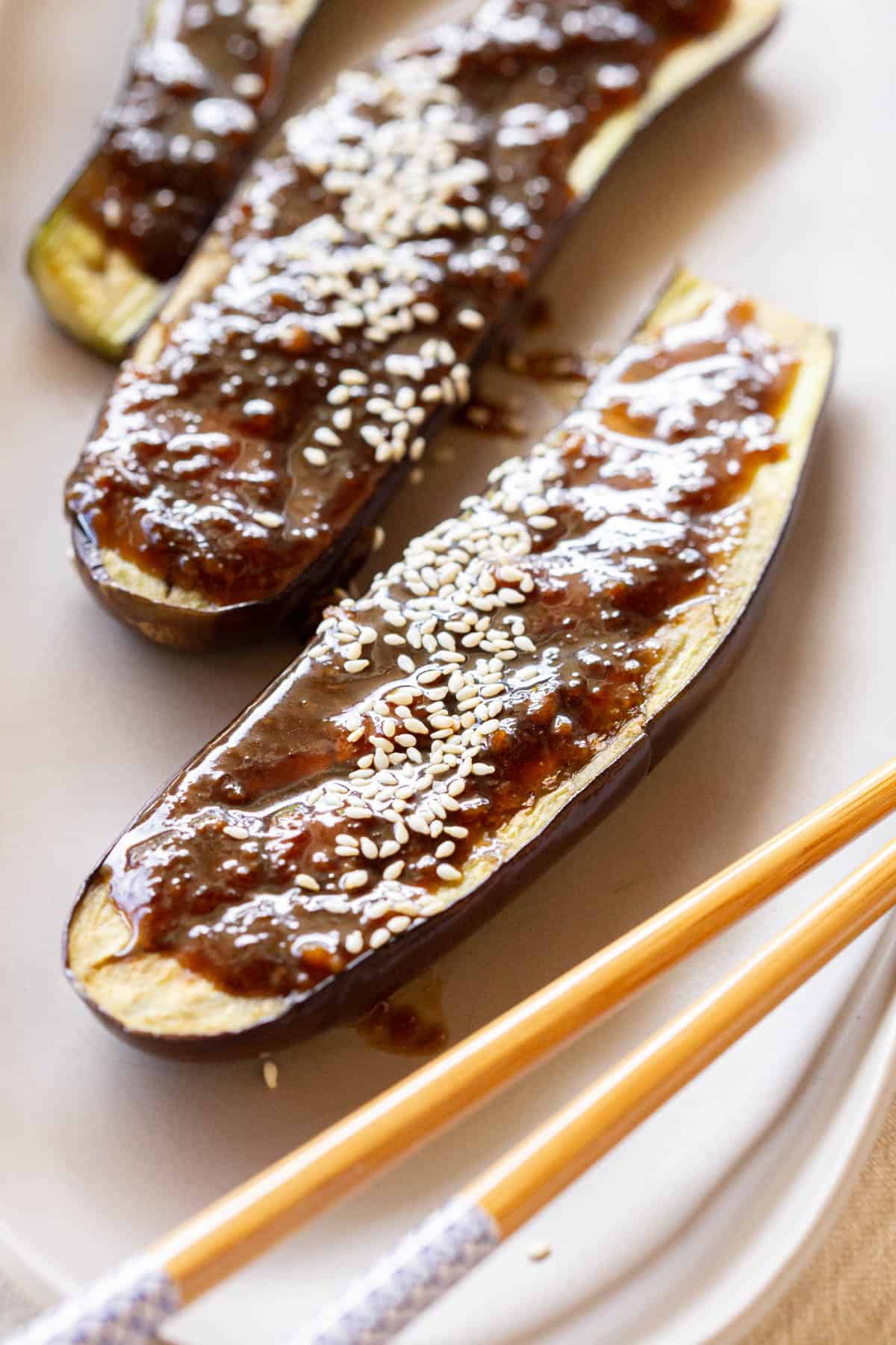 Slices of eggplant topped with a miso glaze and sesame seeds.