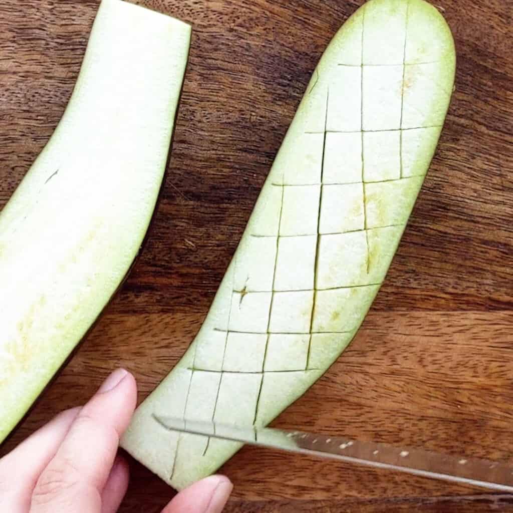 Slicing a cross hatch into the eggplant.