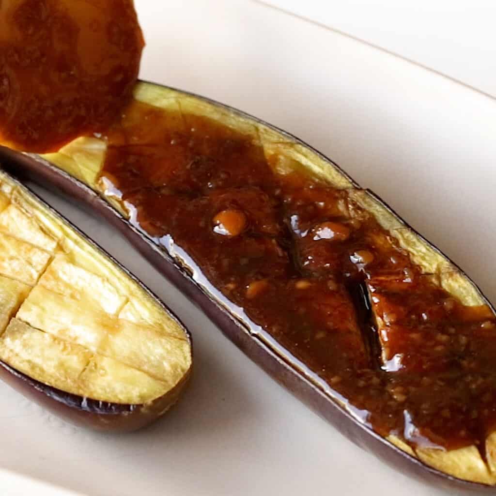 A cooked eggplant topped with the miso glaze sauce.