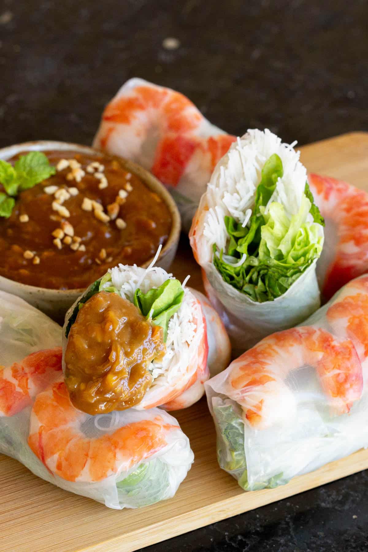 Fresh spring rolls dipped in peanut sauce with hoisin and garlic.