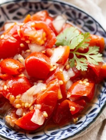 Tomato salsa in a bowl garnished with coriander.